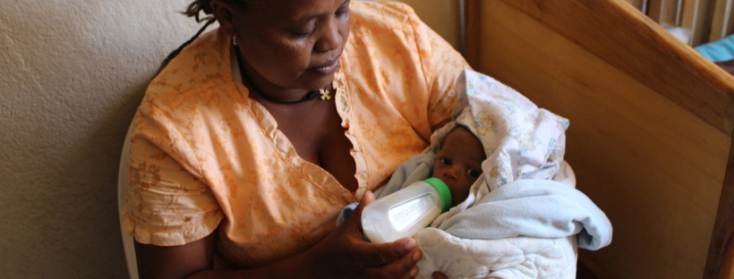 ethopian woman feeding baby formula